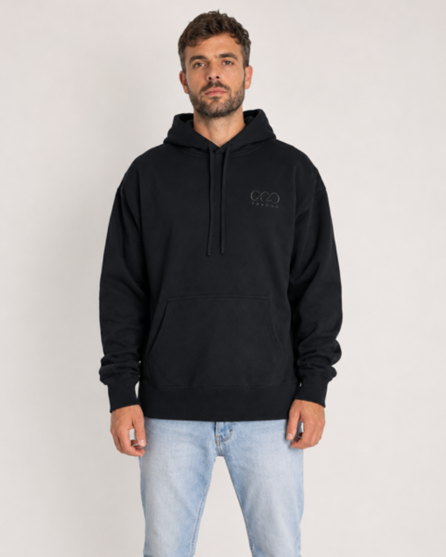 Man wearing a black hoodie with a logo on a white background