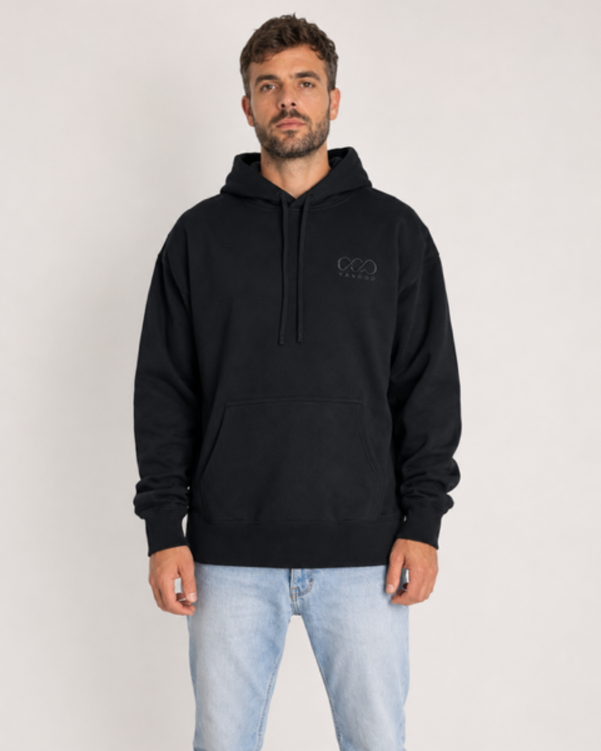 Man wearing a black hoodie with a logo on a white background