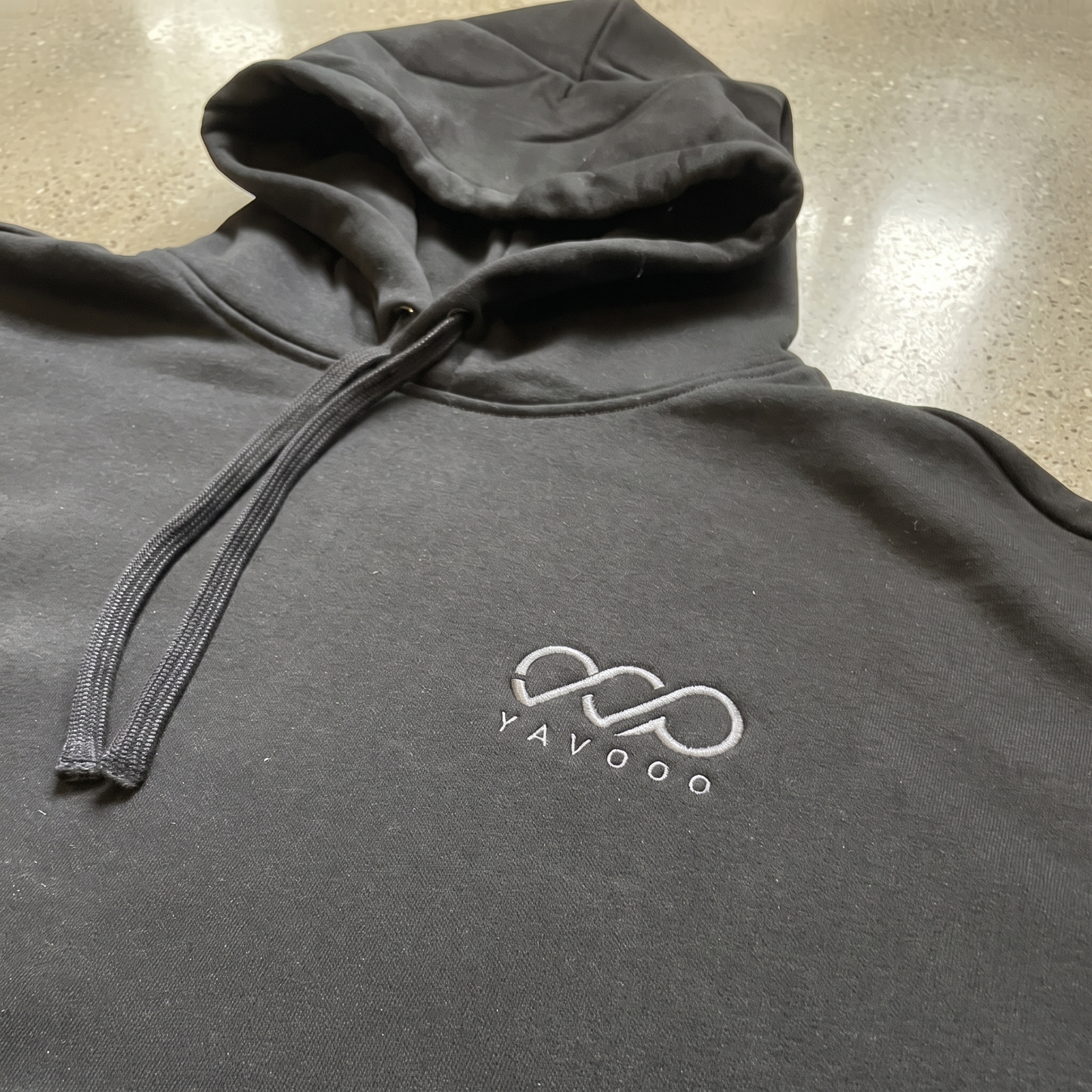 YAVOOO hoodie hood and drawstring detail, light concrete background