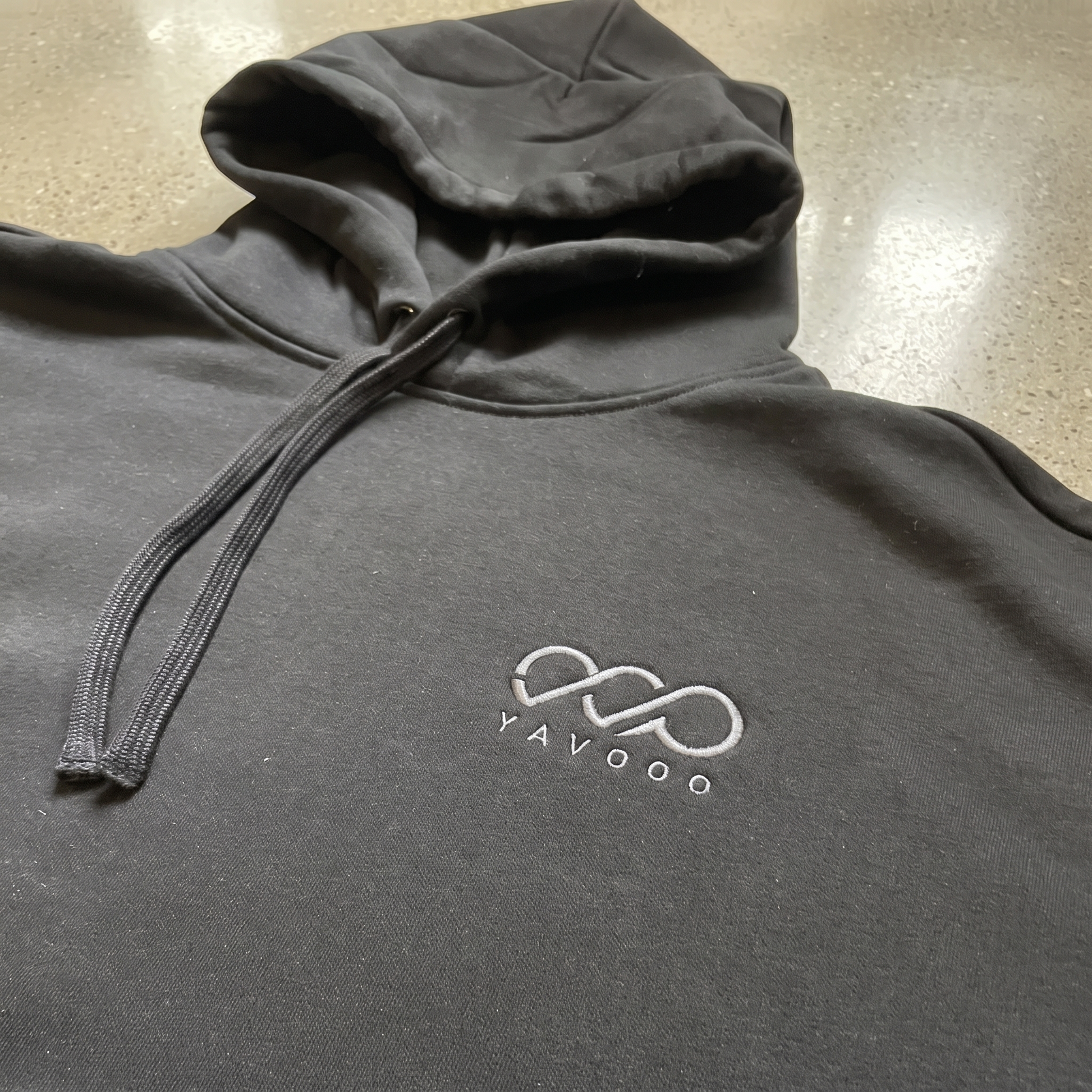 YAVOOO hoodie hood and drawstring detail, light concrete background