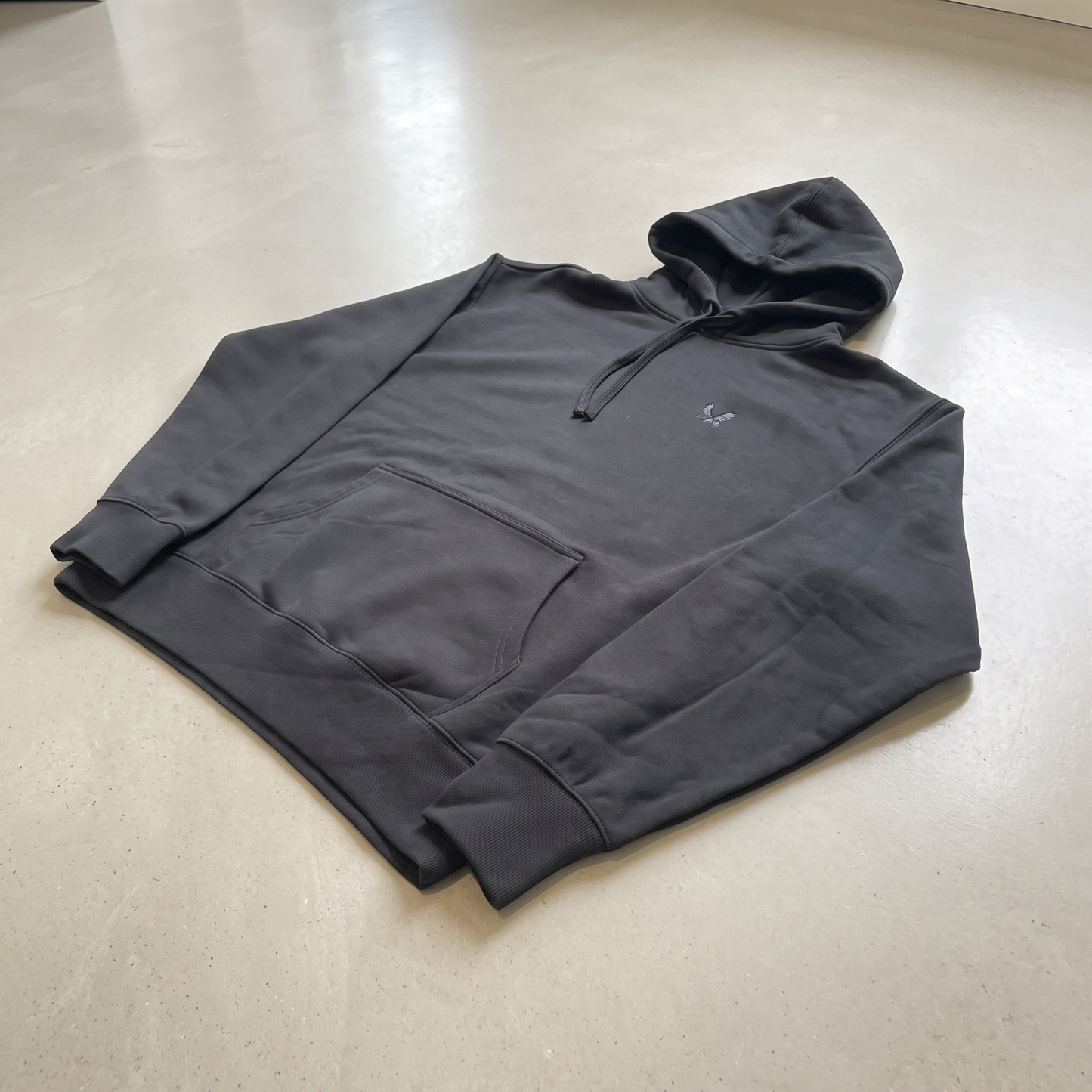 YAVOOO hoodie pocket and sleeve detail, light concrete background