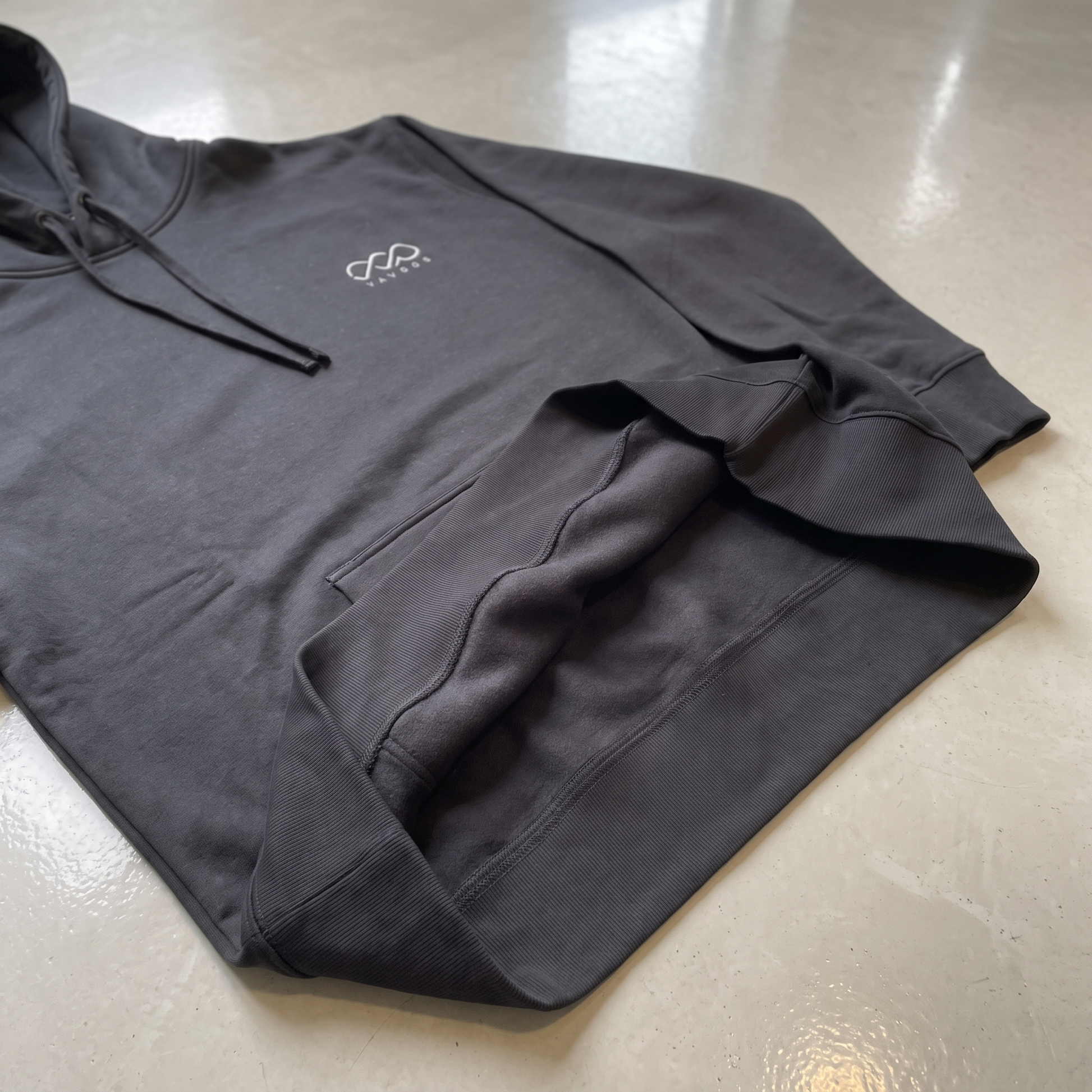 YAVOOO hoodie pocket and cuff detail, light concrete background