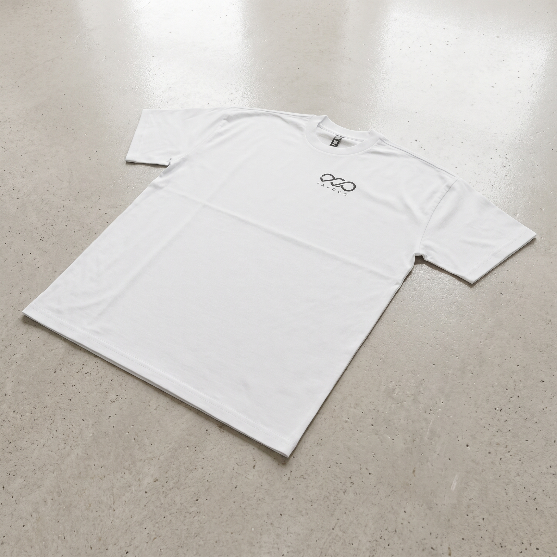 YAVOOO oversized tee back logo detail, light concrete background