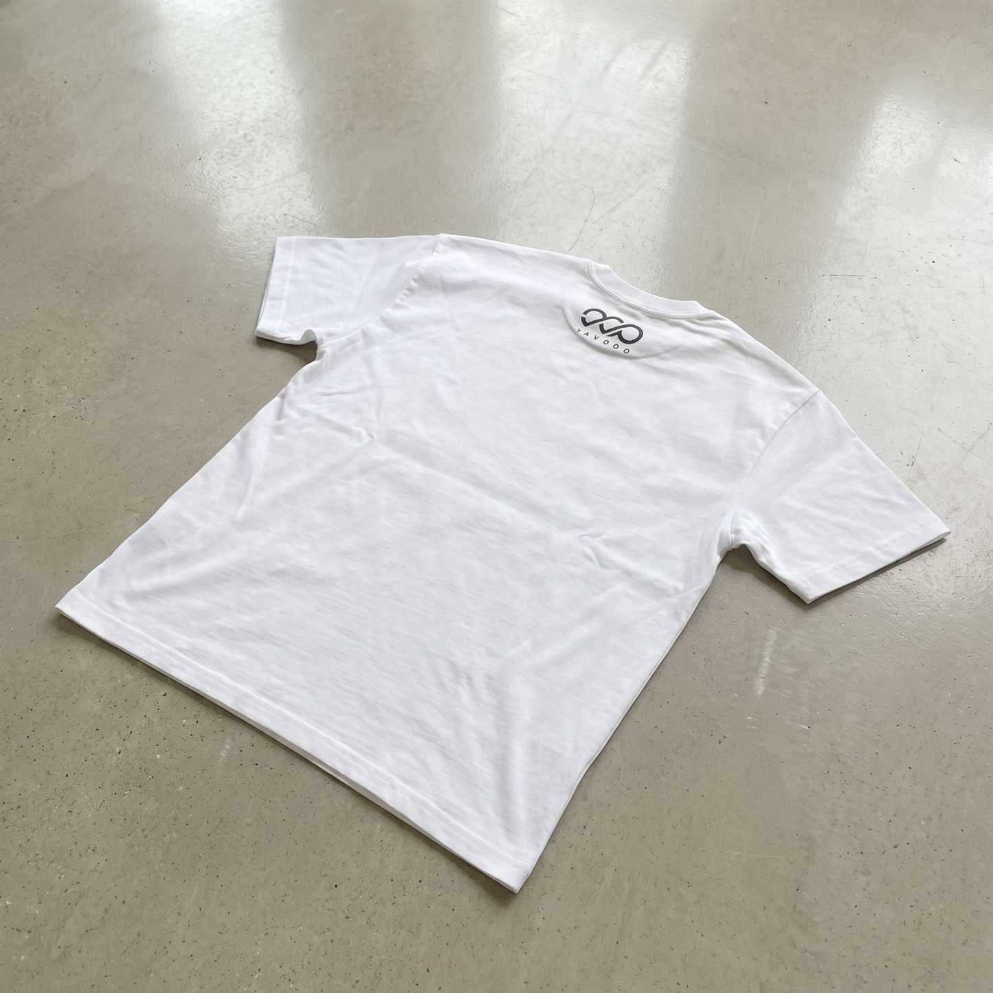 YAVOOO oversized tee front logo centered, light concrete background